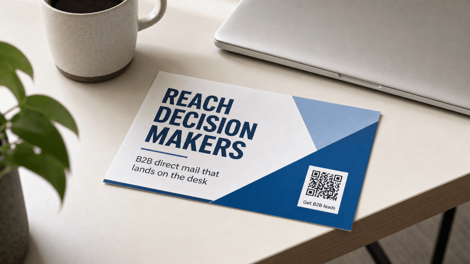 Stack of blank business postcards on a modern office desk with a laptop and coffee, ready for a B2B direct mail campaign