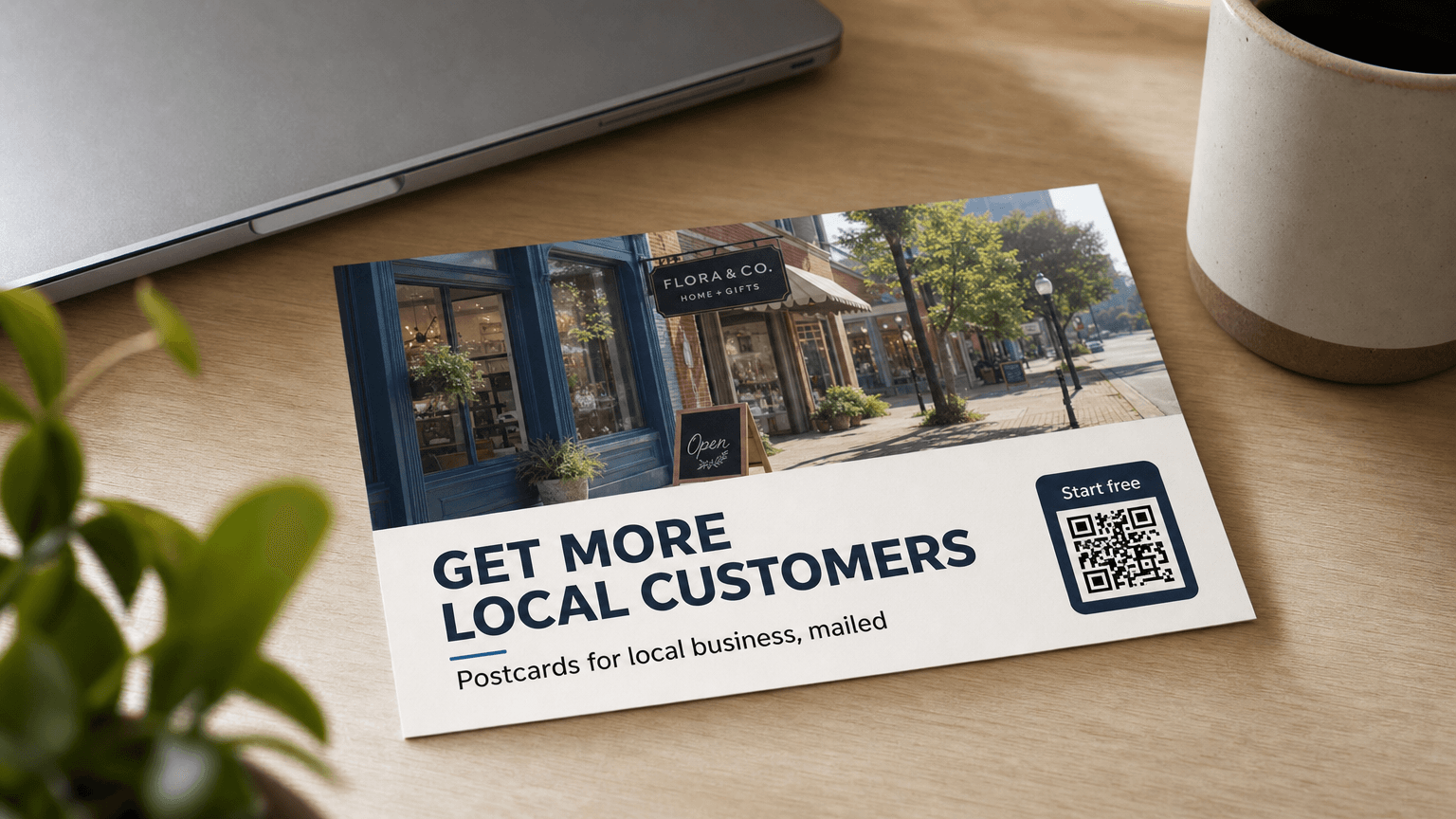 A local business postcard reading 'Get More Local Customers' with a shopfront photo, on a desk.