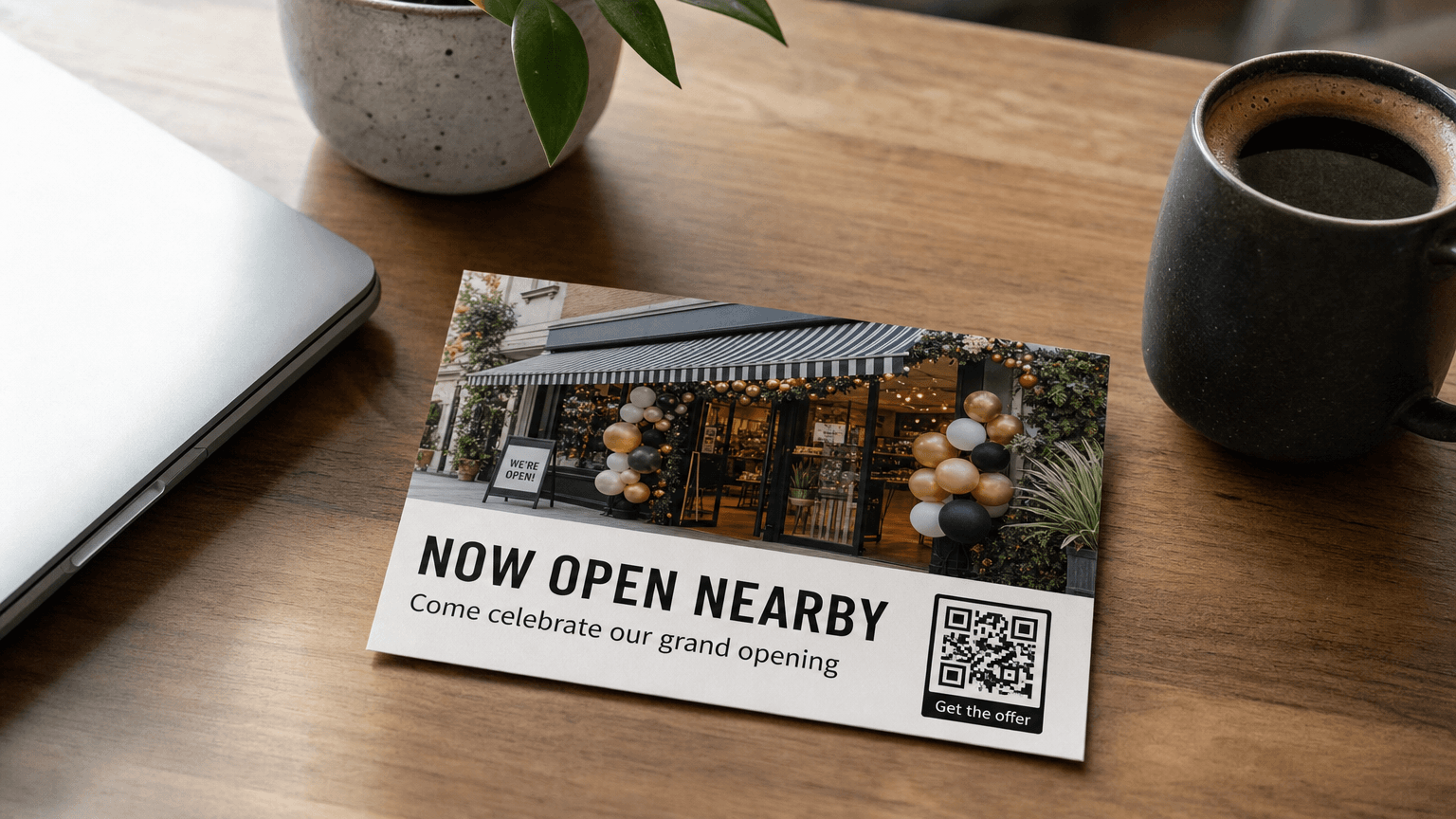 A grand opening postcard reading 'Now Open Nearby' with a new storefront photo, on a desk.